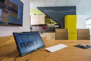 Moderner Beratungsplatz mit Küchenplanung auf Monitoren